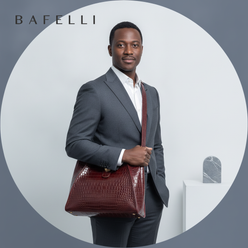 Circular portrait of a man, James Wilson, in a dark suit, holding a charcoal crocodile leather messenger bag. The background 